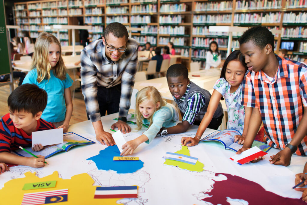 Young people working with an adult in a library